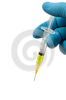 Medical theme of blue latex gloved hand with full syringe. White background.