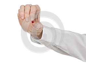 Medical theme: doctor's hand holding a red capsule for health on a white background isolated
