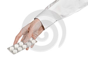 Medical theme: doctor's hand holding a white tablet for health on a white background isolated