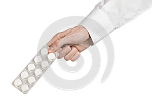 Medical theme: doctor's hand holding a white tablet for health on a white background isolated