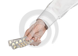 Medical theme: doctor's hand holding a white tablet for health on a white background isolated