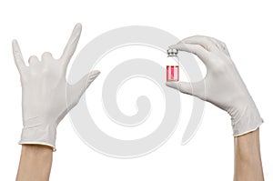 Medical theme: doctor's hand in a white glove holding a red vial of liquid for injection isolated on white background