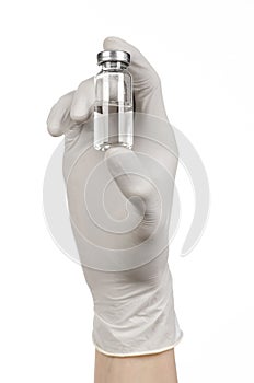 Medical theme: doctor's hand in a white glove holding a vial of clear liquid for injection isolated on white background