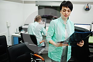 Medical theme. Female doctor hold x-ray in the mri office at diagnostic center in hospital