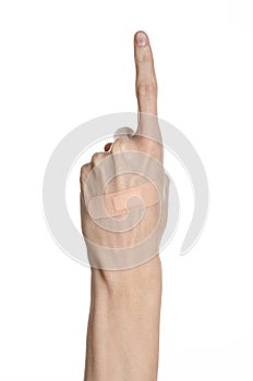 Medical theme: for a man's hand glued medical plaster first aid plaster advertising on a white background
