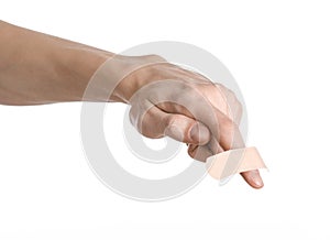 Medical theme: for a man's hand glued medical plaster first aid plaster advertising on a white background