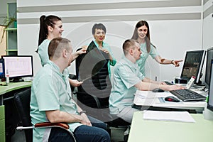 Medical theme.Observation room with a computer tomograph. The group of doctors meeting in the mri office at diagnostic center in