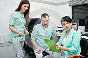 Medical theme.Observation room with a computer tomograph. The group of doctors meeting in the mri office at diagnostic center in