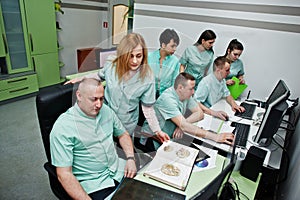 Medical theme.Observation room with a computer tomograph. The group of doctors meeting in the mri office at diagnostic center in