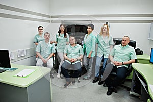 Medical theme.Observation room with a computer tomograph. The group of doctors meeting in the mri office at diagnostic center in