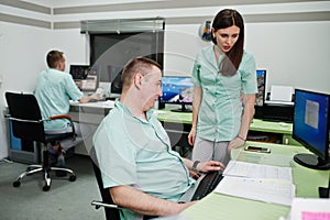 Medical theme.Observation room with a computer tomograph. The group of doctors meeting in the mri office at diagnostic center in