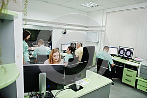 Medical theme.Observation room with a computer tomograph. The group of doctors meeting in the mri office at diagnostic center in