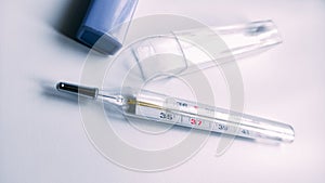 Medical thermometer with heat on white background. Pills for heat and headache.Vaccination effects.