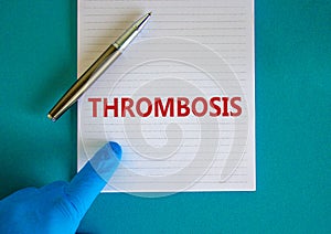 Medical and thrombosis symbol. Doctor hand, metalic pen. White note with the word `thrombosis`. Beautiful blue background. Docto