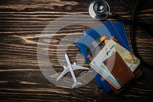 Medical tourism concept - passports, stethoscope, airplane, money photo