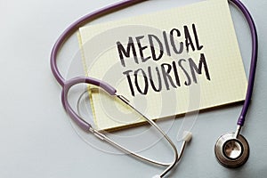 MEDICAL TOURISM written on a clipboard, Medical concept