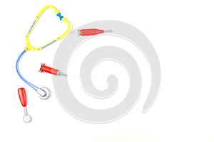Medical toy background. Toy stethoscope and medicine tools on white background.
