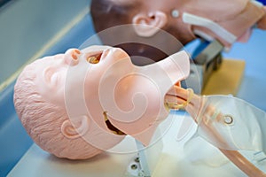 Medical training - intubation of a child sized manikin using an endotracheal tube and video laryngoscopes.