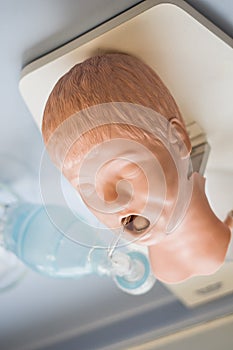 Medical training - intubation of a child sized manikin using an endotracheal tube and video laryngoscopes.