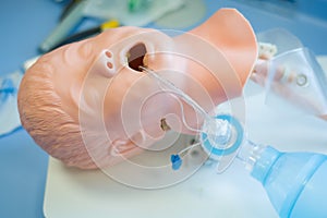 Medical training - intubation of a child sized manikin using an endotracheal tube and video laryngoscopes.