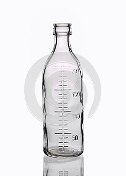 Medical transparent glass bottle with with measuring scale 200 milliliters isolated on a white background