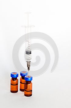 Medical vials, ampules for injection with a syringe on a white background