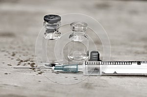 Medical Vials For Injection And Syringe On Wood Table Background