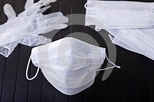 Medical white masks on a black background. Surgical protective mask against viruses and bacteria. The concept of protection photo