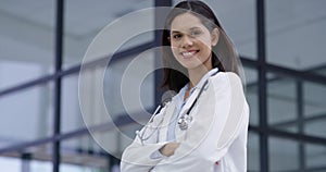 Medical, woman and doctor with smile and arms crossed for trust, medicine or cardiology at hospital or clinic