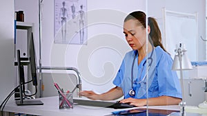 Medical woman nurse typing on computer patient health report