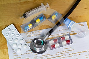 Medical work stop notice, black stethoscope, syringe and packs of pills