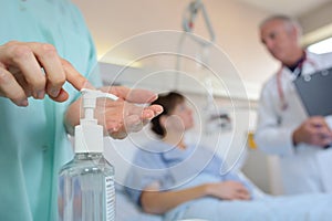 Medical worker applying hand sanitizer photo