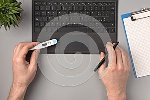 Medical worker checking the temperature measurment results. Working concept, flat lay