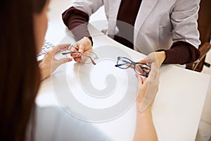 Medical worker handing over two spectacles pairs