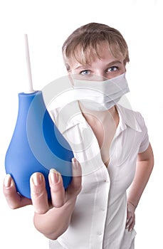 Medical worker holding a blue enema in her hands photo