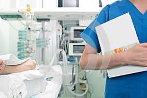 Medical worker holding textbook in the ward