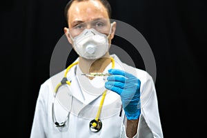 A medical worker holds a medical mercury thermometer in his hands. Measurement of body temperature during coronavirus infection. A