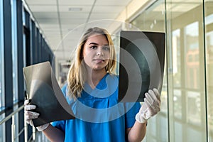 Medical worker looks at xray film of the skull to detect signs of the disease