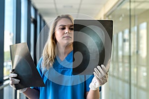 Medical worker looks at xray film of the skull to detect signs of the disease