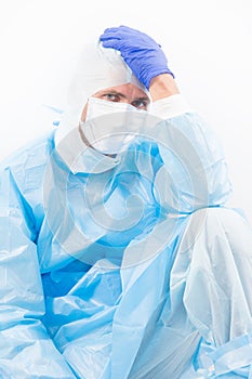 Medical worker man in protective costume isolated on white having covid19 sars virus symptoms of headache, coronavirus
