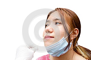 Medical worker with protective equipment performs coronavirus swab on girl