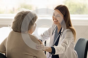 Medical worker support to old lady in clinic