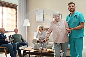 Medical worker taking care of elderly woman in hospice