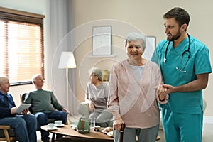 Medical worker taking care of elderly woman in hospice