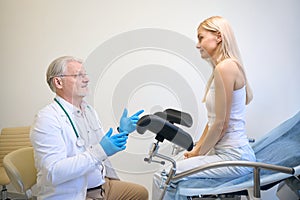 Medical worker talking with lady in hospital