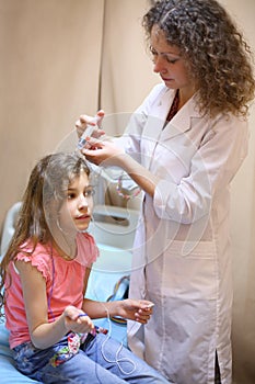 Medical worker will put electrode gel on the girls photo