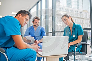 Medical workers having a changeover and watching something online