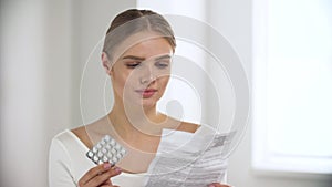 Medicament. Woman Reading Pills Instruction At Light Interior