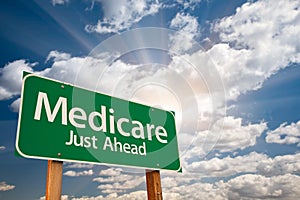 Medicare Green Road Sign Over Clouds photo