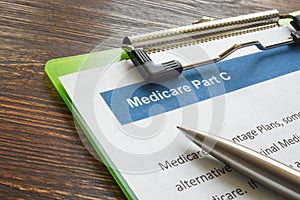 Medicare part C insurance papers with clipboard and pen. photo